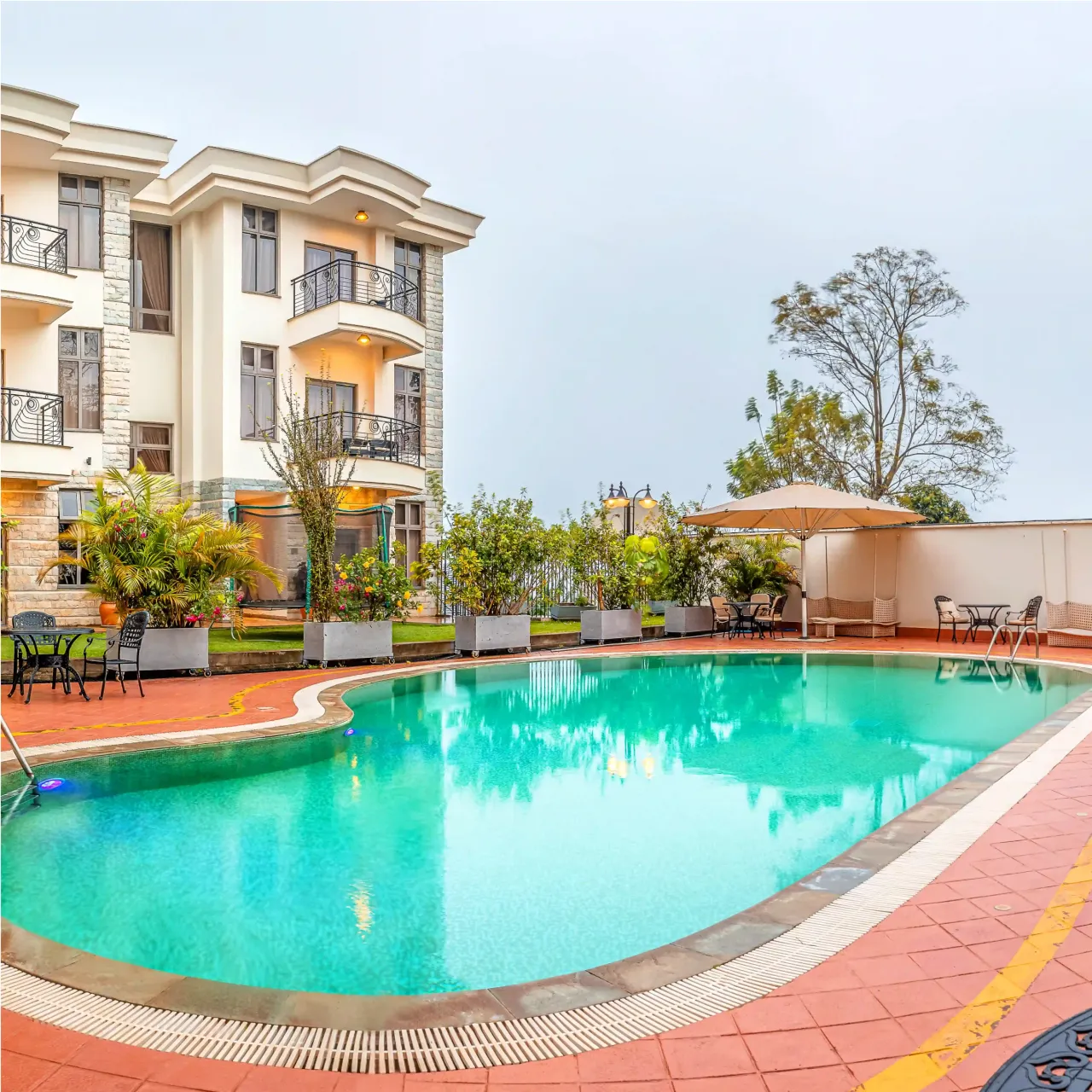 Outdoor swimming pool with lounge chairs at Alba Hotel